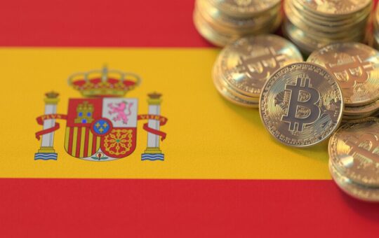 A pile of tokens representing Bitcoin on the Spanish flag.